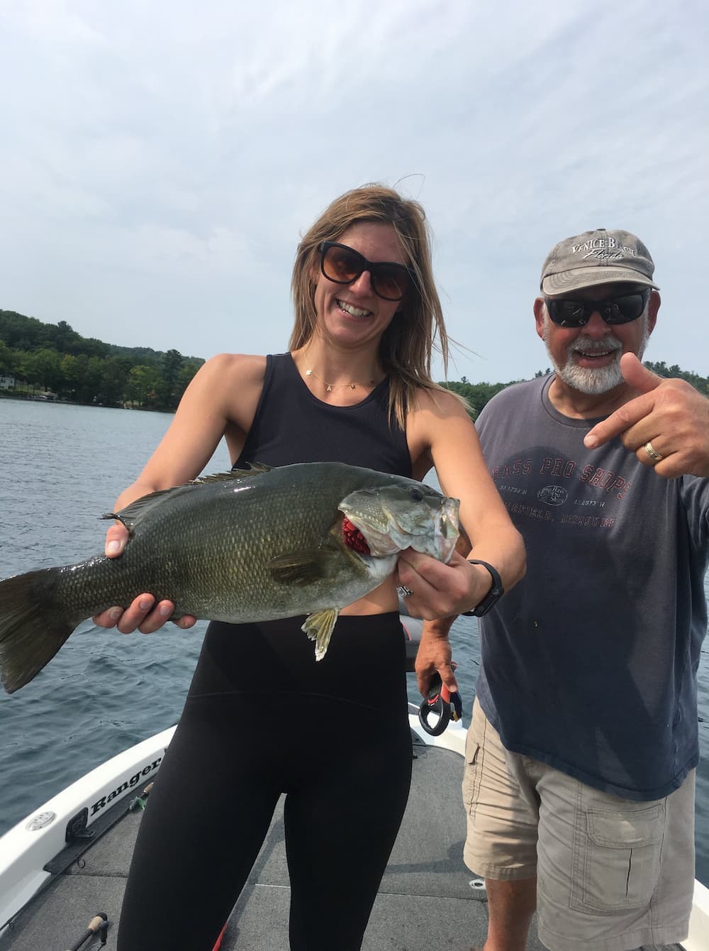 Customer and Captain Butch with a large smallmouth bass on Grand Traverse Bay
